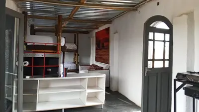 a room with white shelves and an open door at River Rock Safari Hebron, Kgabakatsane