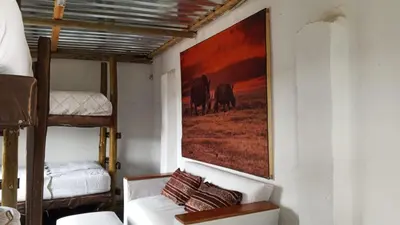 a room with a couch and a painting on the wall at River Rock Safari Hebron, Kgabakatsane