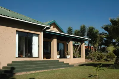 a house with stairs leading up to a window at Elephant's Nest in Graskop
