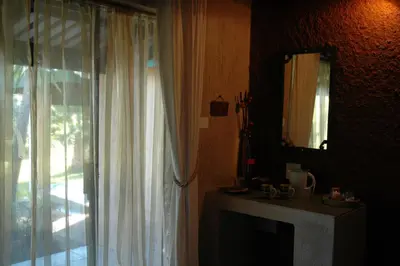 a room with a window and a mirror and a table at Elephant's Nest in Graskop