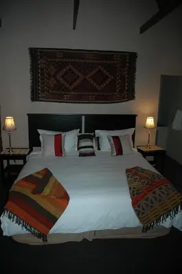a bedroom with a large white bed with pillows at Elephant's Nest in Graskop