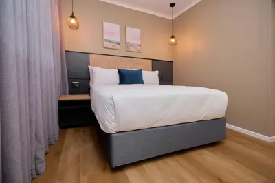 a bedroom with a large bed and a desk at Unit 109 at Glen Park in Pretoria
