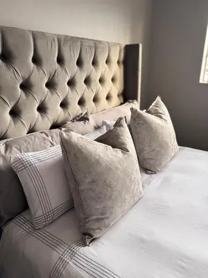 a bed with pillows on it in a bedroom at Menlyn Private Escape in Pretoria