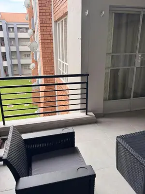 a balcony with a chair and a bench on a building at Menlyn Private Escape in Pretoria
