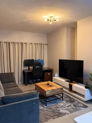 a living room with a large flat screen tv at Menlyn Private Escape in Pretoria