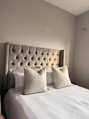 a white bed with two pillows on top of it at Menlyn Private Escape in Pretoria
