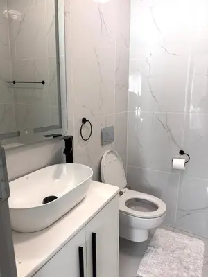 a white bathroom with a sink and a toilet at Menlyn Private Escape in Pretoria
