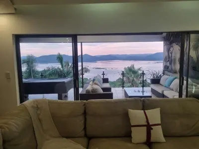 a living room with a couch and a view of the ocean at MiCasa in Hartbeespoort