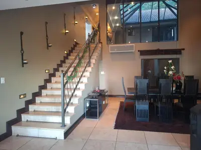 a staircase in a building with a table and chairs at MiCasa in Hartbeespoort