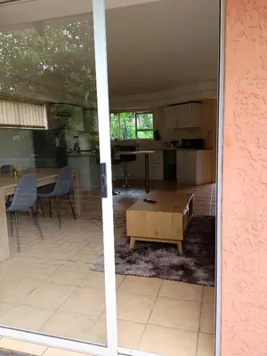 a living room and kitchen with a table and chairs at Sandton Elite Stay in Sandton
