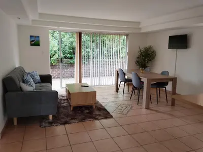 a living room with a couch and a table at Sandton Elite Stay in Sandton