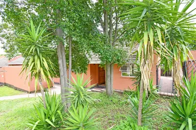 a house with palm trees in front of it at Sandton Elite Stay in Sandton