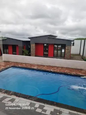 a building with a swimming pool in front of it at Vegas guest house in Dwarsloop