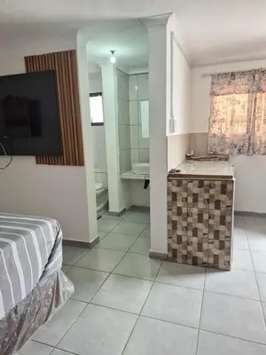 a bedroom with a bed and a bathroom with a sink at Vegas guest house in Dwarsloop