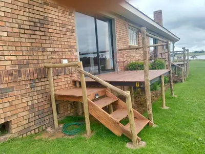 a wooden deck on the side of a building at Witbank Dam Self Check In in Witbank