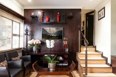 a living room with a couch and a table at InnJoy Boutique Hotel in Centurion