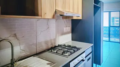 a kitchen with a stove top oven next to a sink at Cosy 1 bedroom Apartment in Midrand