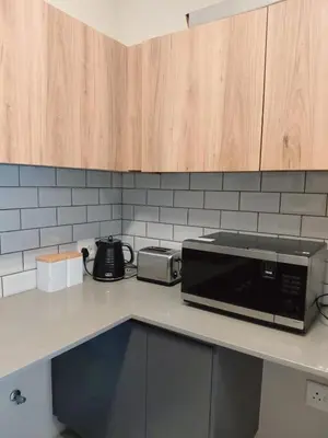 a microwave sitting on top of a kitchen counter at Cosy 1 bedroom Apartment in Midrand