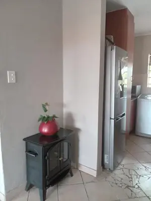 a red apple sitting on top of a black cabinet in a kitchen at Nested at L&M in Centurion