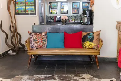 a couch with colorful pillows on it in a room at Khayamanzi Guesthouse in Hartbeespoort