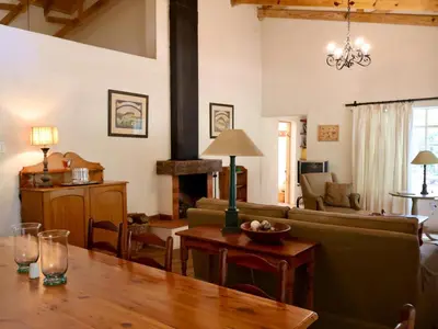 a living room with a couch and a table at Winnaarspoort Lodge in Machadodorp