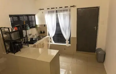 a kitchen with a counter top and a window at Thorne's crip in Pretoria