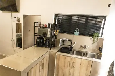 a kitchen with a sink and a counter top at Thorne's crip in Pretoria