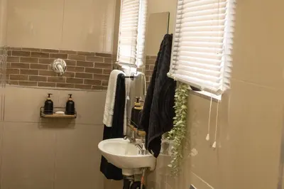 a bathroom with a sink and a mirror at Thorne's crip in Pretoria