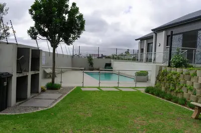 a house with a swimming pool in a yard at WiFi, Washer, Smart TV, Balcony & Pool in Midrand