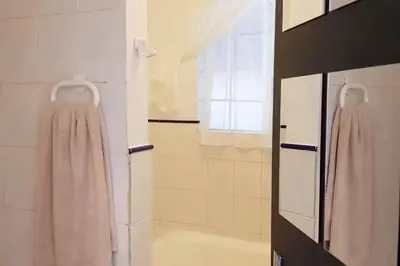 a bathroom with a shower and a bath tub at Lodge At The Link in Kempton Park