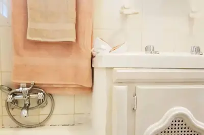 a bathroom with a sink and a toilet and a mirror at Lodge At The Link in Kempton Park