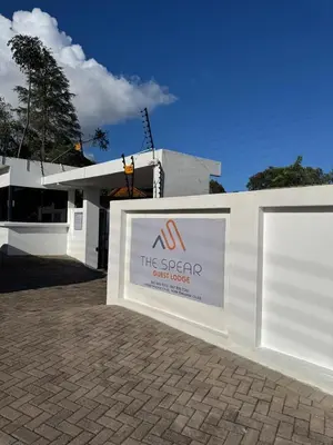 a sign for the spaental agent center in front of a building at The Spear Guest Lodge in Graskop