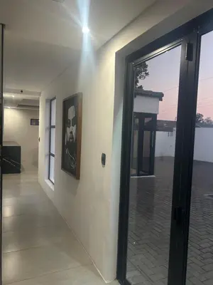 a door to a room with a view of a building at The Spear Guest Lodge in Graskop