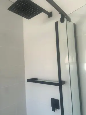 a shelf in a glass wall with a light fixture at The Spear Guest Lodge in Graskop