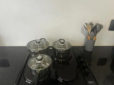 a stove top with three pots on top of it at The Spear Guest Lodge in Graskop