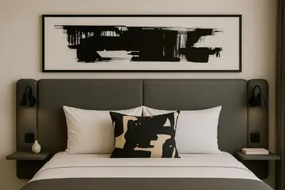 a bedroom with a bed with a picture on the wall at The Spear Guest Lodge in Graskop