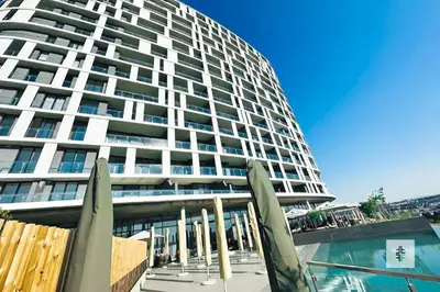 a large building with a swimming pool in front of a building at Fezkho Boutique Stays in Midrand