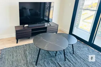 a living room with a table and a tv at Fezkho Boutique Stays in Midrand