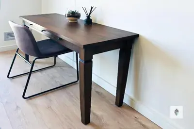 a wooden desk with a chair next to a wall at Fezkho Boutique Stays in Midrand