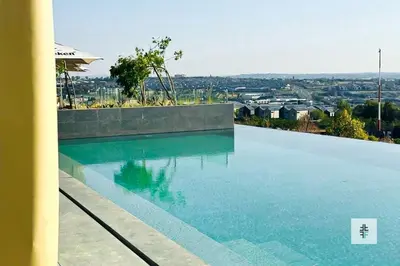 a swimming pool with a view of a city at Fezkho Boutique Stays in Midrand