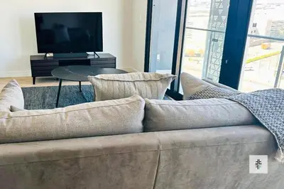 a living room with a couch and a television at Fezkho Boutique Stays in Midrand