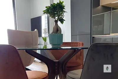 a dining room table with a potted plant on it at Fezkho Boutique Stays in Midrand