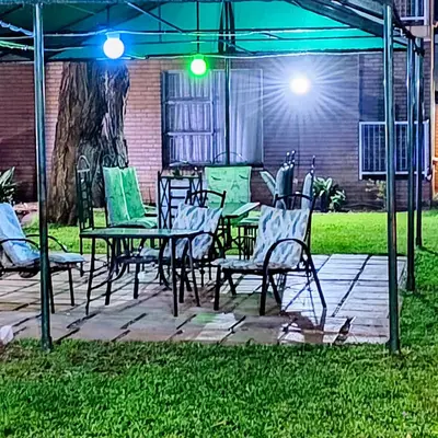 a patio with a table and chairs under a tent at Africa Lodges in Thabazimbi