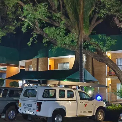 a white truck parked in front of a building at Africa Lodges in Thabazimbi