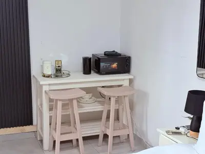 a microwave sitting on a table with two stools at 43 Home Reyno Ridge in Witbank