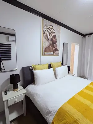 a bedroom with a bed and a painting on the wall at 43 Home Reyno Ridge in Witbank