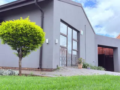 a white building with a tree in front of it at 43 Home Reyno Ridge in Witbank