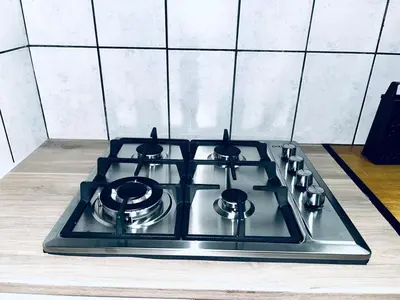 a stove top with four pots and pans on it at Stylish 1 Bed Self Catering Near OR Tambo in Kempton Park