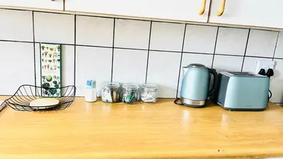 a kitchen counter with a toaster and jars on it at Stylish 1 Bed Self Catering Near OR Tambo in Kempton Park