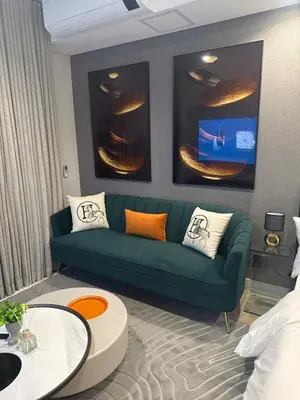 a living room with a green couch and a table at 4413 At Ellipse Waterfall in Midrand
